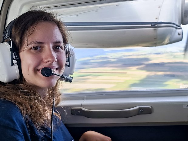 Ayleen sitzt im Flugzeug über dem Wattenmeer.
